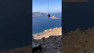 Little kid getting comfortable on a climbing rope
