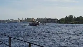 A hydrofoil boat sails under the bridge