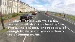 Silly driver cuts in on cyclist around bend.