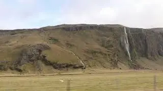 Driving by waterfalls in Iceland