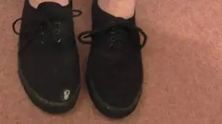 A black oxford lace plimsoll ripped up