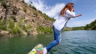 in jeans on a water board