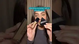 Blending concealer with a powder puff 