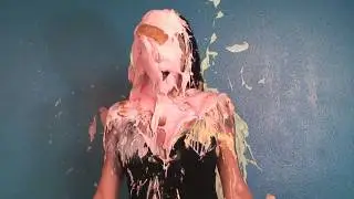 Woman pied in the face and covered in pink gunge