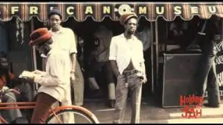Holding on to Jah: Don Carlos blesses Gregory Isaacs