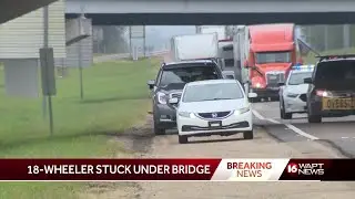 Truck gets stuck under an overpass
