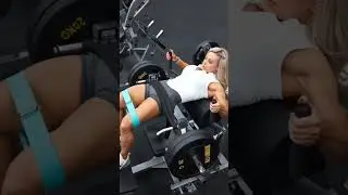 Female Australian Personal Trainer Utilizing Gym Machines/R. Bands For Lower Body Workout
