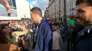 Acrobatic performance from the Statue of Eros, Piccadilly, LONDON UK