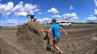 Таксист Артур и его жена и я,катаемся на тюках сена в Беларуси.