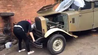 Cute Red Head girl starts vintage car by crank handle - Real Woman!