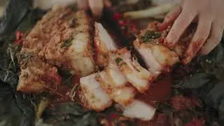 Stuffed pork belly with burdock grass leaves. Kohlrabi, sesame leaves, lettuce, spicy cabbage