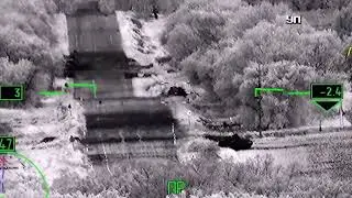 A Russian helicopter destroys a Ukrainian tank at a checkpoint