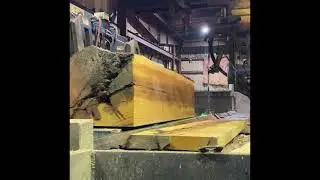 Big red cedar high grade log on a doublecut carriage with a slabber