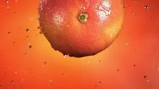 Flying of Grapefruit in Orange Background in Slow Motion