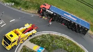 VN24 - Semitrailer lies on its side in traffic circle - tow truck in action