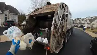 Garbage man POV: Manual trash on a Mack MR McNeilus rear loader garbage truck Part 1