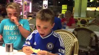 Kid eats a lemon first time.