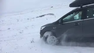 My Wife is riding in the snow on a Ford Kuga
