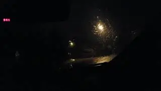 Gentle rain falling on my garage shutters and my car with windows open
