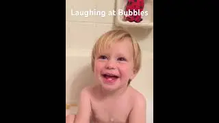 Laughing at bubbles in the bathtub