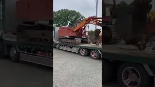 Beautiful loader Carry big Excavator on road in Japan