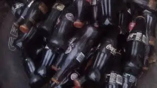 collection of old vintage coke bottles found in the woods