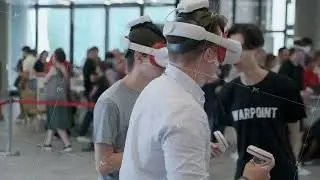 Man experiencing virtual reality with VR headset at tech event