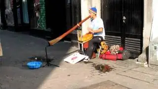 Busker in Galway playing the didgeridoo and the bongos at the same time.