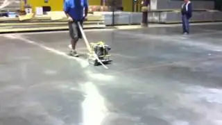 Saw cutting new fresh concrete floor