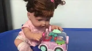Baby doll playing with toys.