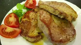 PORK STEAK in a frying pan.