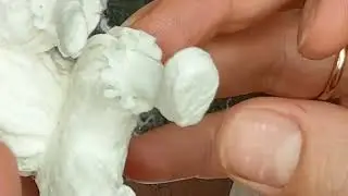 I'm showing the process of creating frills on a cotton wool toy's clothes.