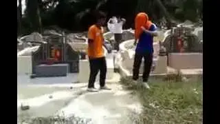 Disrespectful behavior - Malay play at chinese grave