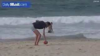Chris and Bec Judd have fun at the beach while on holiday in Noosa