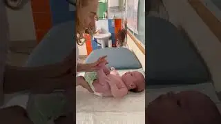 If the baby arches his back while on his stomach and throws his head back, what should you do?