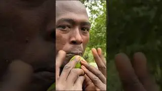 Surma tribe man whistles with fruit 