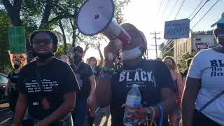 Black and Prideful Marchers Chant and Sing