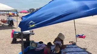 Crown Shades Canopy on the Beach with the wind blowing