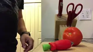 Destemming a tomato with a strawberry destemmer
