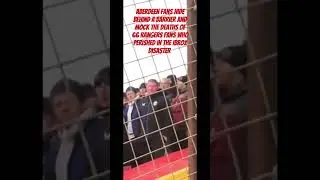 Aberdeen fans hide behind a barrier and mock the deaths of the victims of the Ibrox disaster