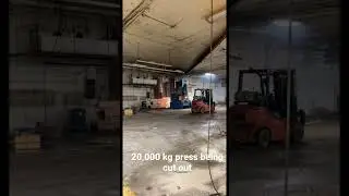 Large press being cutout of building