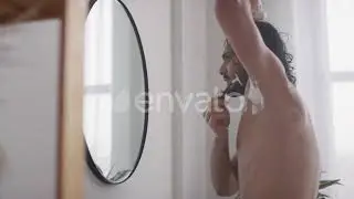 Young Man Shaving His Armpits in front of the Mirror | Stock Footage - Envato elements