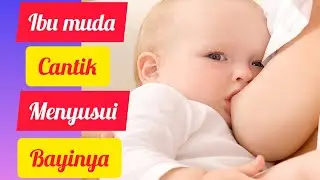 Ibu muda cantik lagi menyusui bayinya sambil main ayunan