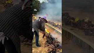 Burning 10,000 bamboo tubes of sticky rice for the merit-making festival in the third lunar month...