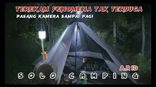 solo camping in the forest cooking fish and leunca