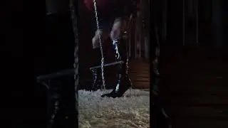Crossdresser Bondage of the legs with a chain He was wearing patent black  boots and black stockings