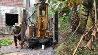 Dig a well in the mountain by water well drilling machine