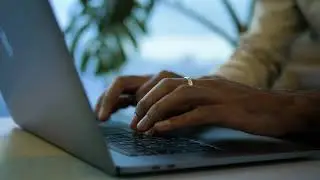 Hands typing away on a laptop | Free stock Mac video