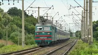 An old freight electric locomotive VL80T-1489 rushes with a passenger train