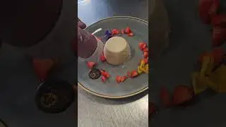 Crafting perfection: Watch as our chef skillfully plates our delicious panna cotta dessert! 🍮